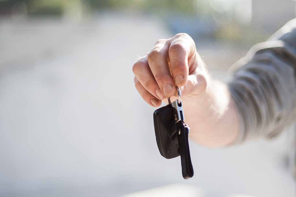dealership giving keys to customer